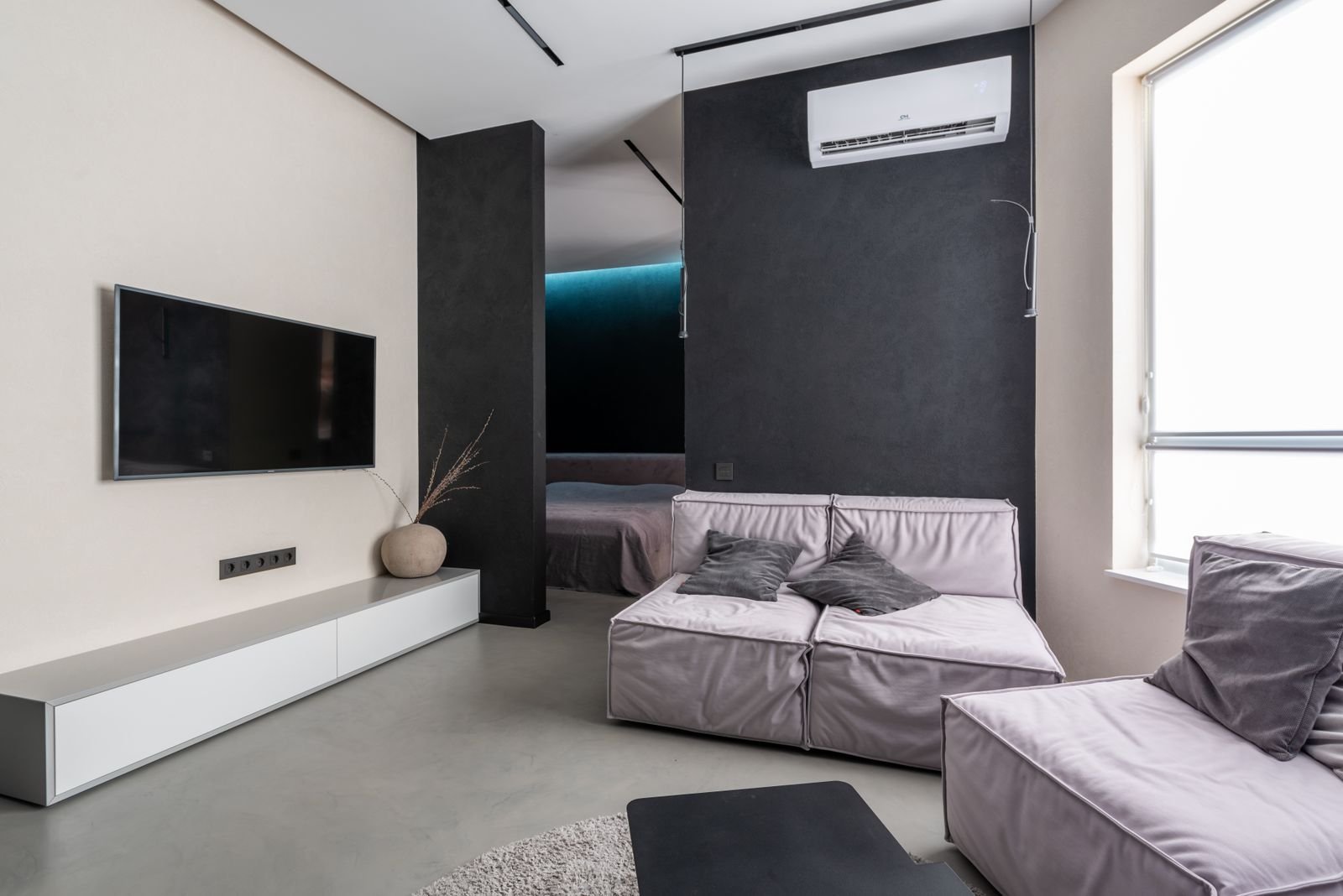 Gemuetliches Wohnzimmer mit Sofa und Fernseher